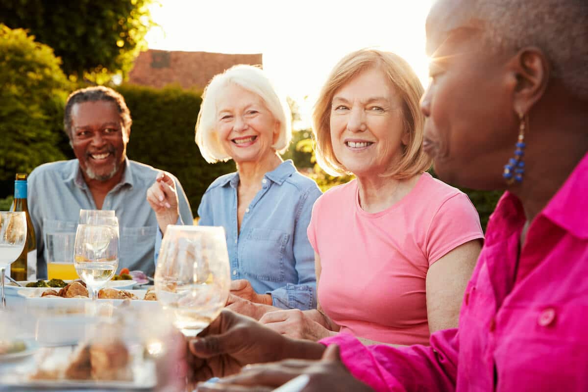 Barton House Memory Care | Seniors having dinner outside