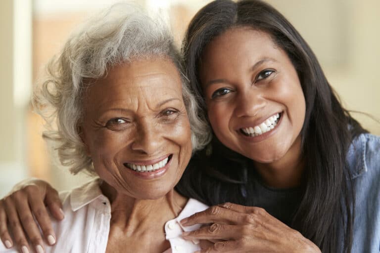 Barton House Memory Care | Senior woman and her daughter smiling