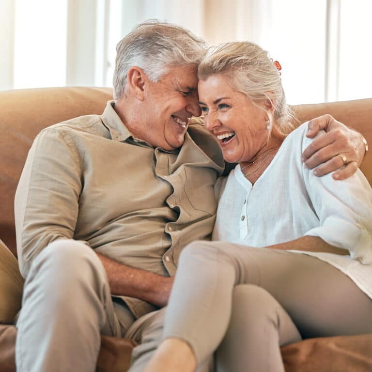 Barton House | Senior couple embracing on the sofa