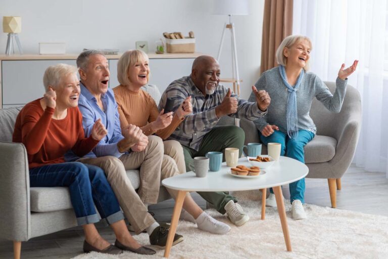 Camlu Assisted Living | Emotional seniors watching television in the living room