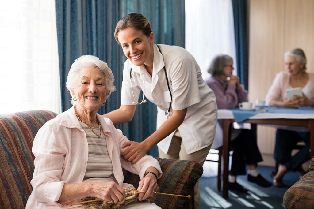 Camlu Assisted Living | Senior woman and caregiver smiling