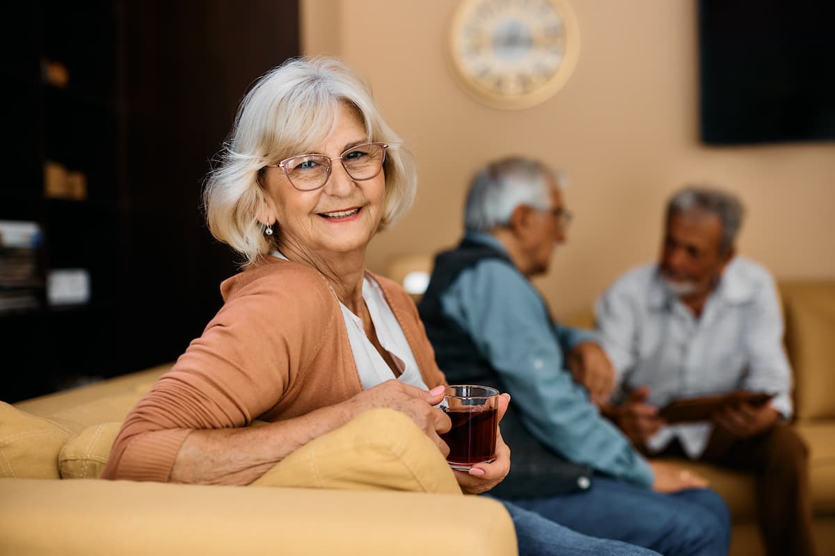 Novellus Clairemont | Happy senior woman drinking coffee