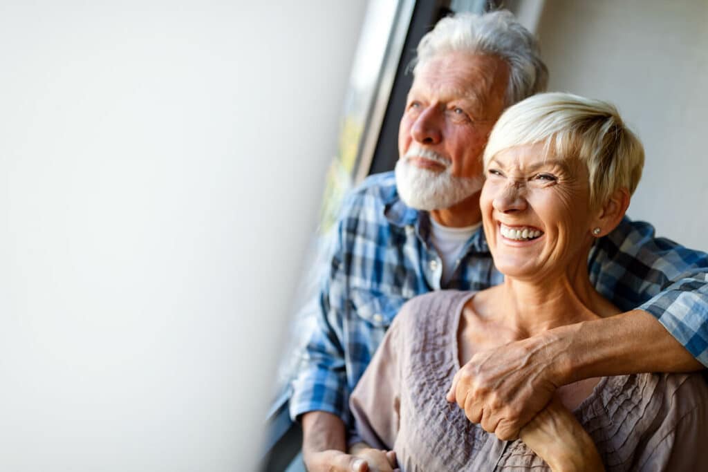 Novellus Cypresswood | Senior couple smiling out a window