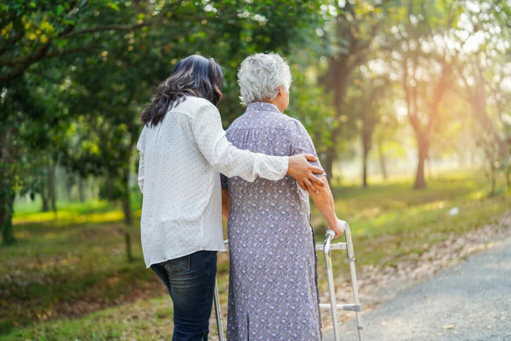 Novellus Cypresswood | Senior woman with a walker going for a walk with her caregiver