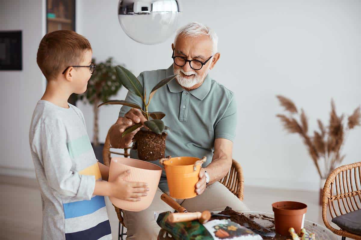 Novellus Cypresswood | Senior man laughing and gardening with his grandson