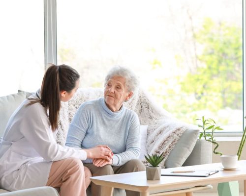 Novellus Cypresswood | Senior with caregiver on couch