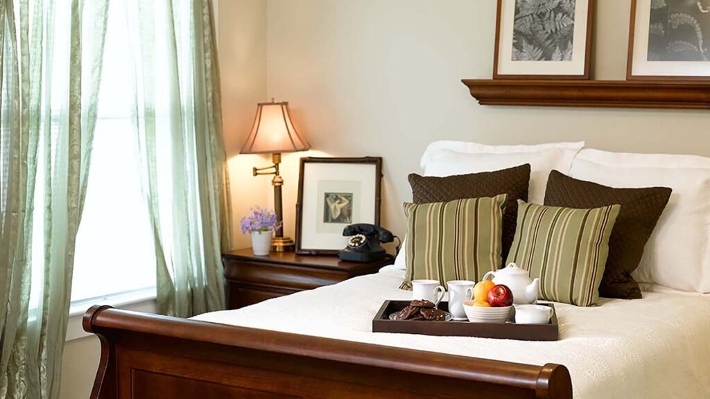 Novellus Kingwood | Bedroom with breakfast tray on the bed