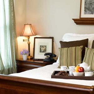 Novellus Kingwood | Bedroom with breakfast tray on the bed