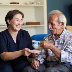 Orangeburg Memory Care | Professional helpful caregiver and a senior man during home visit