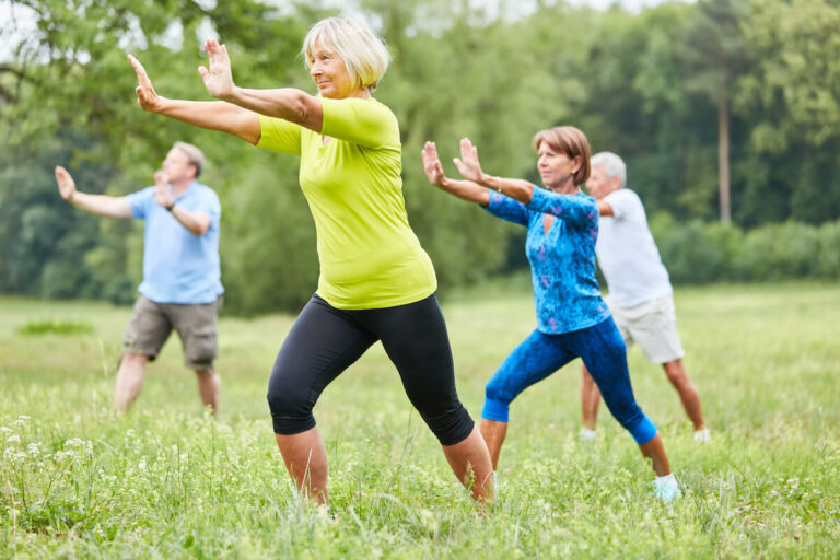 Orangeburg Memory Care | Seniors doing yoga outside