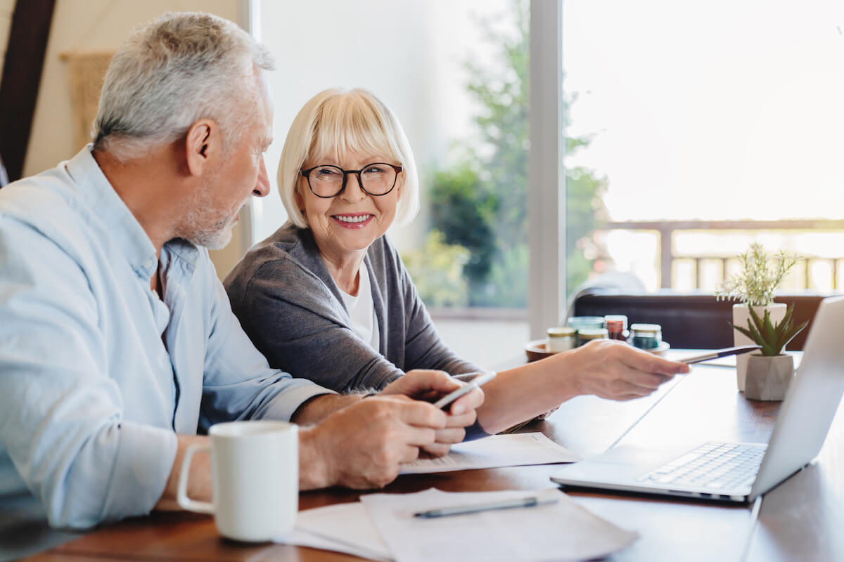 Orangeburg Memory Care | Senior couple smiling and looking at a computer