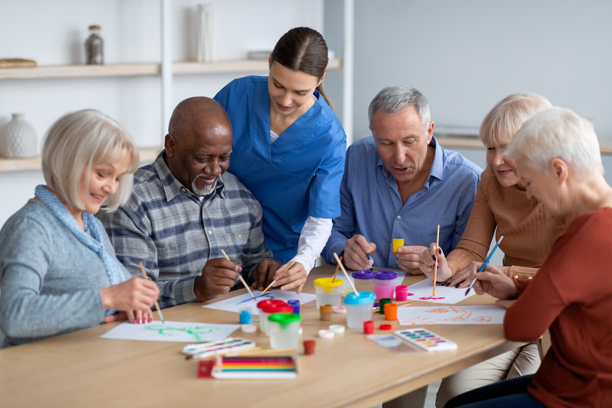 Orangeburg Memory Care | Group of seniors crafting at a table