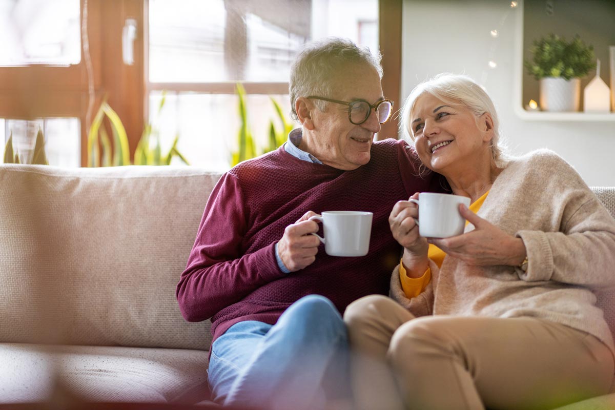 Stockton Assisted Living | Senior couple drinking coffee while sitting together on a couch
