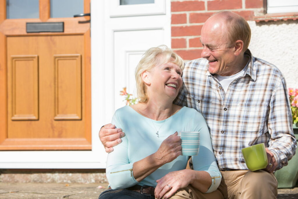 Stockton Assisted Living | Senior couple sitting outside their home drinking coffee