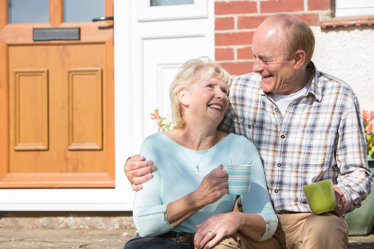 Stockton Assisted Living | Senior couple sitting outside their home drinking coffee