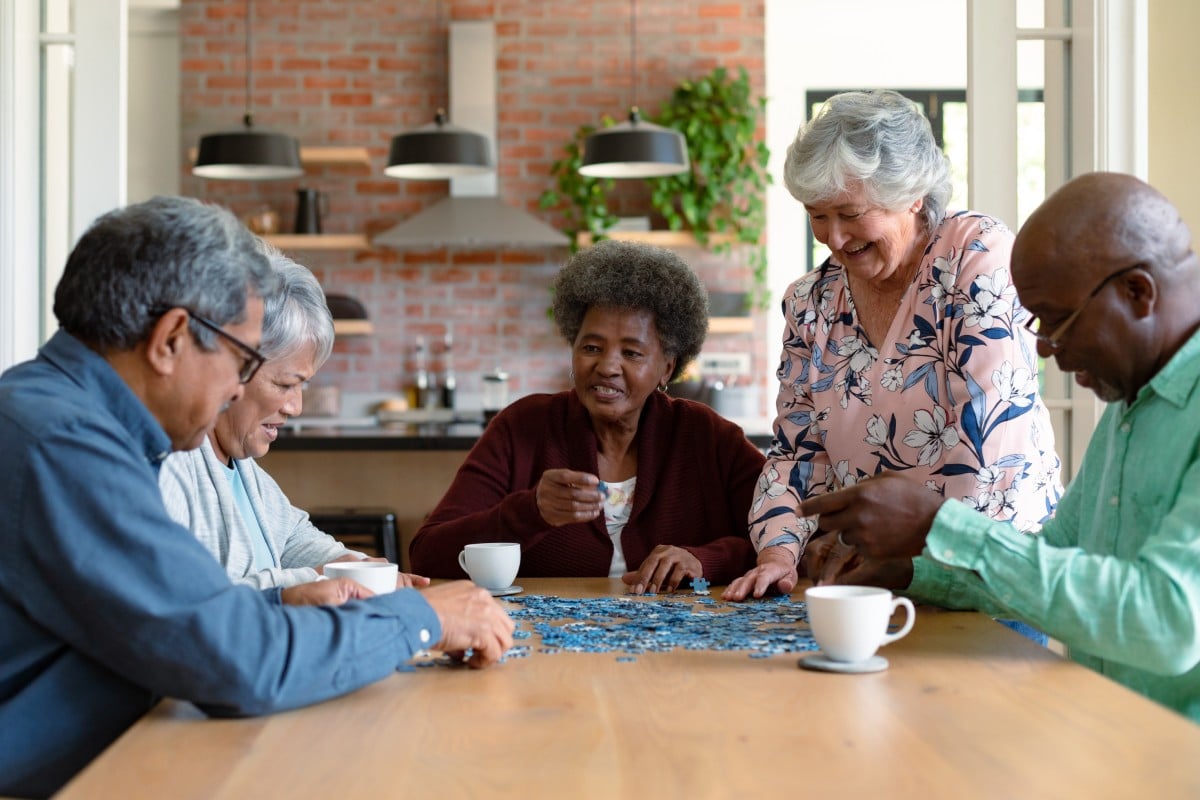 Stockton Assisted Living | Group of seniors working on a puzzle
