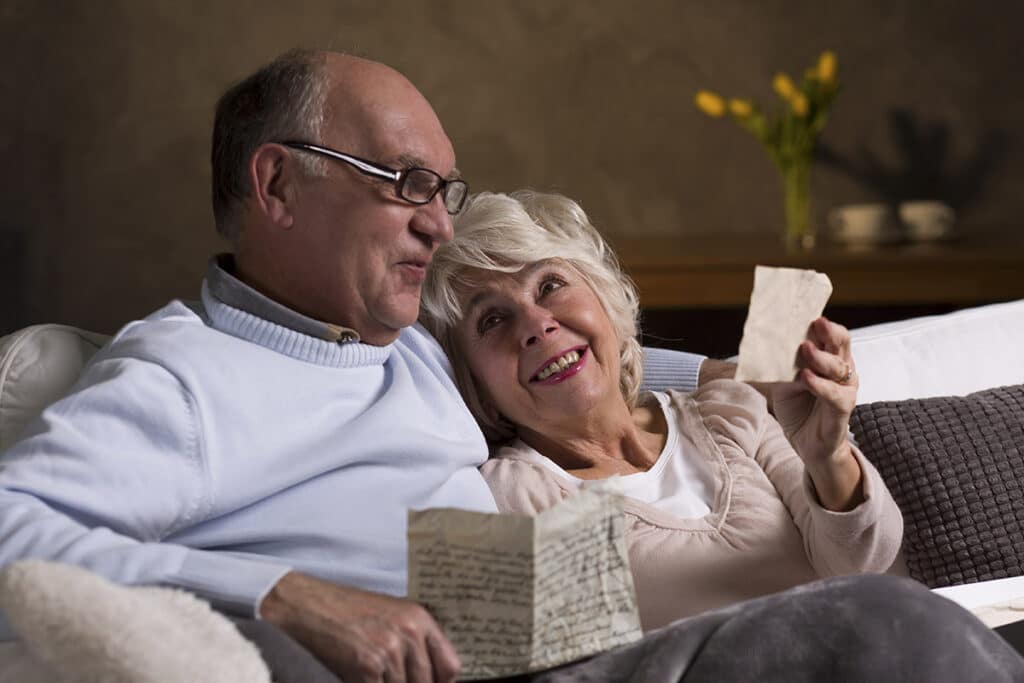 Orangeburg Memory Care | Senior citizens reading old letters and recalling memories